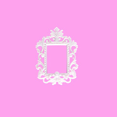 Ornate white vintage frame, isolated against bright pink background. 