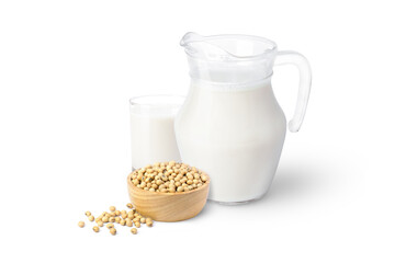 Fresh soy milk in glass pitcher and soybeans in wooden bowl isolated on white background.