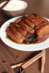 Braised Pork Belly with Pickled Cabbage and Steamed Rice on Wooden Table