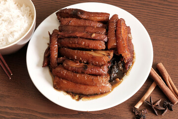 Braised Pork Belly with Pickled Cabbage and Steamed Rice on Wooden Table