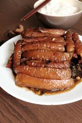 Braised Pork Belly with Pickled Cabbage and Steamed Rice on Wooden Table