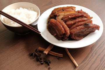 Braised Pork Belly with Pickled Cabbage and Steamed Rice on Wooden Table