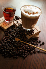 hot coffee and hot tea, coffee beans on wooden table