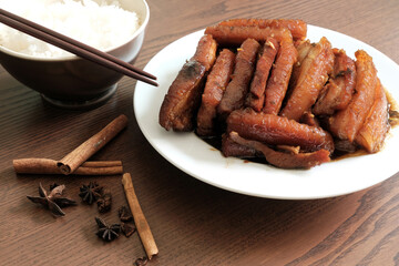 Braised Pork Belly with Pickled Cabbage and Steamed Rice on Wooden Table