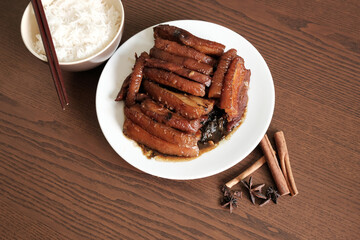 Braised Pork Belly with Pickled Cabbage and Steamed Rice on Wooden Table