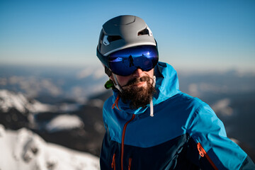 Portrait of man with ski helmet and goggles against a blurred background