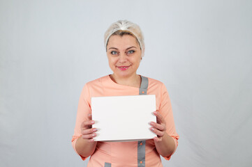 Beautiful ukraine woman in cook clothes holds white paper box on white background