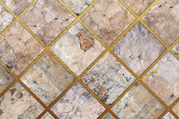 Old, faded and cracked wall collage with golden frames. Concrete, cement and golden wall pattern. Symmetric and abstract broken on textured Background