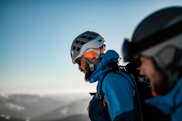 head side view of a man with ski helmet on his head against a blue sky background