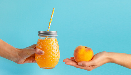 Eco friendly lifestyle and healthy food concept. Smoothie jar and peach on blue background. Copy space