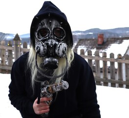 Armed steampunk person sitting spying and keeping low profile with gas mask helmet and holding gun...