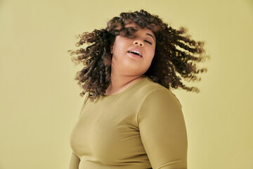 Studio shot of young woman shaking head