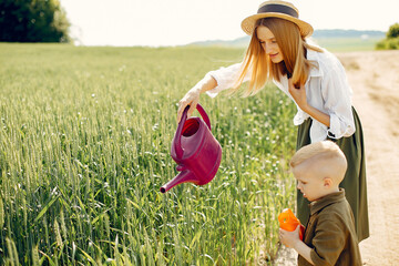 Beautiful mother with little son in a summer field