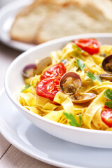 Seafood Tagliatelle Noodles with Fresh Tomatoes on a Plate.