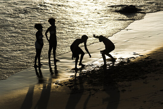 A silhouette of tourists having fun on the Ondina beach in Salvador city, Bahia in Brazil