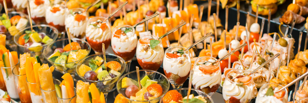 Photo of a lot of delicious fruit desserts and aperitives for a party.