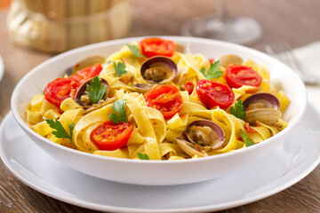 Seafood Tagliatelle Noodles with Fresh Tomatoes on a Plate.