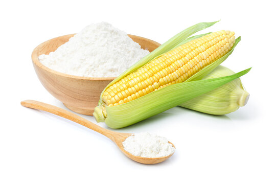 Corn starch in wooden bowl and spoon with fresh sweet corn isolated on white background. 