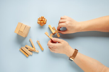 Wooden table game block puzzle abstract and components on blue  background. Top view