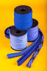 Colorful fabric accessories or pieces standing on a yellow background. accessories and rubber...