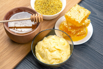 Fresh flower honey of different varieties, pollen and honeycomb with spoons on a wooden background. Organic Vitamin Health Food