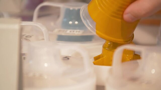 Process of pouring yellow pigment paste into the dispenser container.