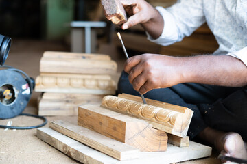 close up shot of carpenter making wood design by using carpentry tools at workplace - concept of skilled occupation, creativity, small business and local artisans.