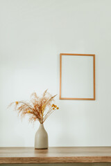 Wooden picture frame and dried flowers pampas grass i