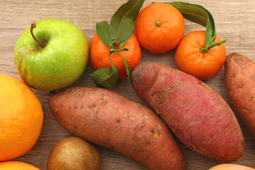 Various healthy fruit and vegetable on wooden background. Top view.