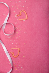 festive pink background with sparkles and hearts