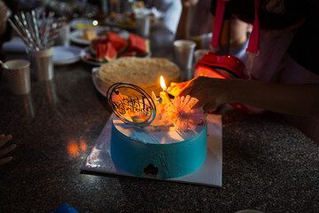 Birthday cake, presents, hats over light grey.