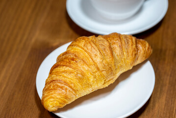 Fresh croissant on a rustic background
