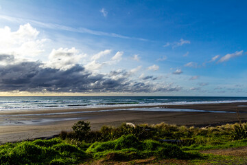 Fototapeta na wymiar Waves and black sand highlight a visit to the beach. Taranaki, Beach, Taranaki, New Zealand..