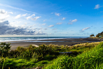 Waves and black sand highlight a visit to the beach. Taranaki, Beach, Taranaki, New Zealand..