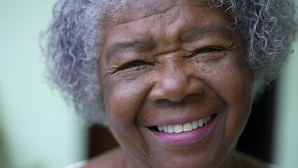 Portrait of a happy senior African woman face smiling at camera - Powered by Adobe
