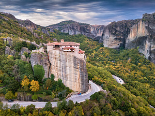 Fototapeta na wymiar Majestic view of one of the famous meteora destinations - Holy Monastery of Rousanos Saint Barbara situated on a high cliff. Great Wonders of Greece concept