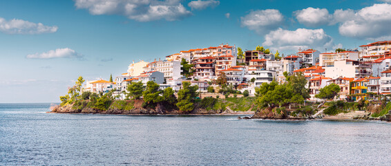 Houses and villas in a resort town Neos Marmaras in Sithonia, Halkidiki, Greece on mountain slope...