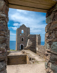 Wheal Coates tin mine,roofless engine house ruins,looking through old doorway,under open skies,Cornwall,England,UK.