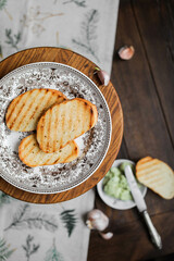 Three slices of grilled white bread on a plain plate
