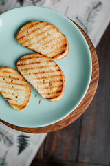 Three slices of grilled white bread on a plain plate