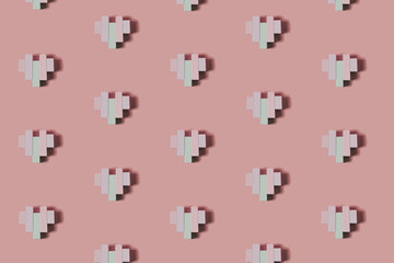 Creative pattern made of wooden block heart shapes. Love visual with pastel colors. Minimal flat lay background.