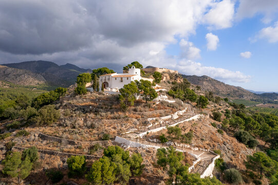 Drone view of La Magdalena Hermitage and old castle ruins on top of the hill in Castellon with blue sky and some clouds