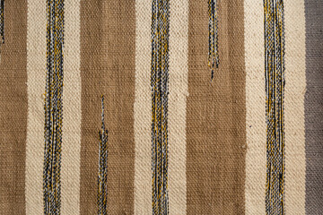 The texture of the fabric. Beige striped rug.
