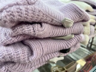 heap of purple sweaters folded with alarm