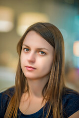 Close-up portrait of a beautiful young girl with dark brown hair.