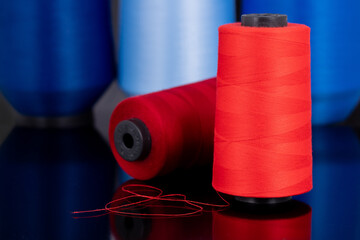 red sewing thread standing in an isolated environment