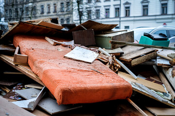 Construction waste. Broken furniture and household waste during the reconstruction of the apartment. Illegal dumping. Selective focus - obrazy, fototapety, plakaty