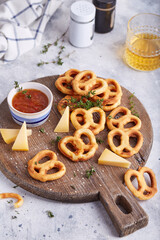 Cheese pretzels snacks pastries served with sauce and thyme