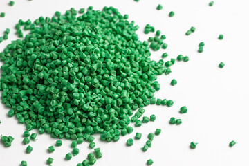 green granules of polypropylene, polyamide. White background. Plastic and polymer industry....