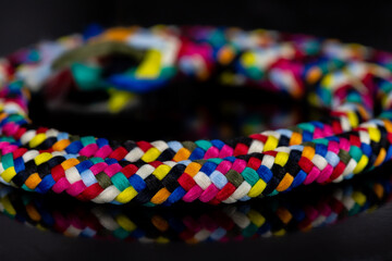 Textile accessory or colored threads drawn on a black background. colored knitting yarn